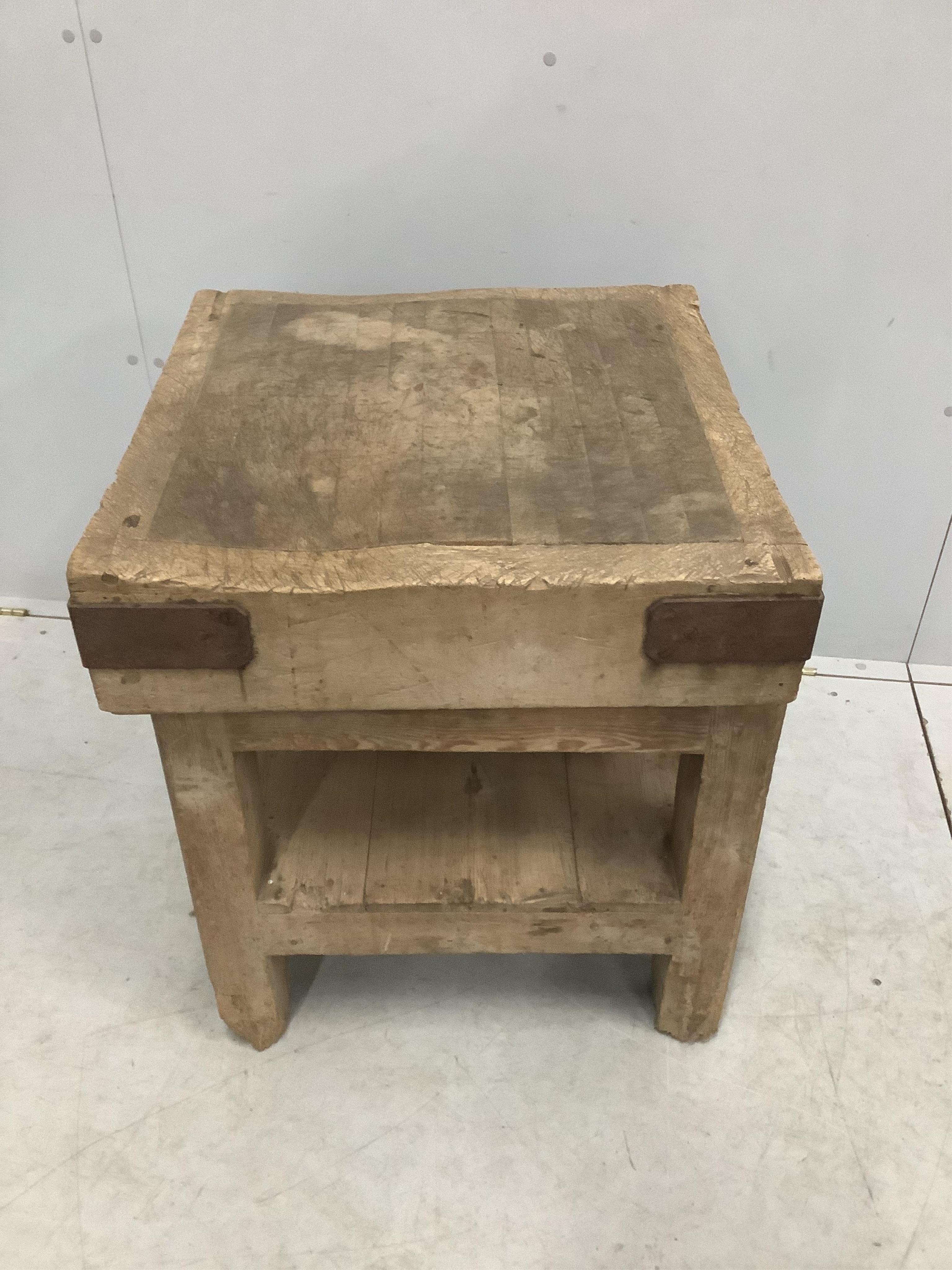 A Victorian iron bound butcher's block on pine stand, width 62cm, depth 61cm, height 68cm. Condition - fair